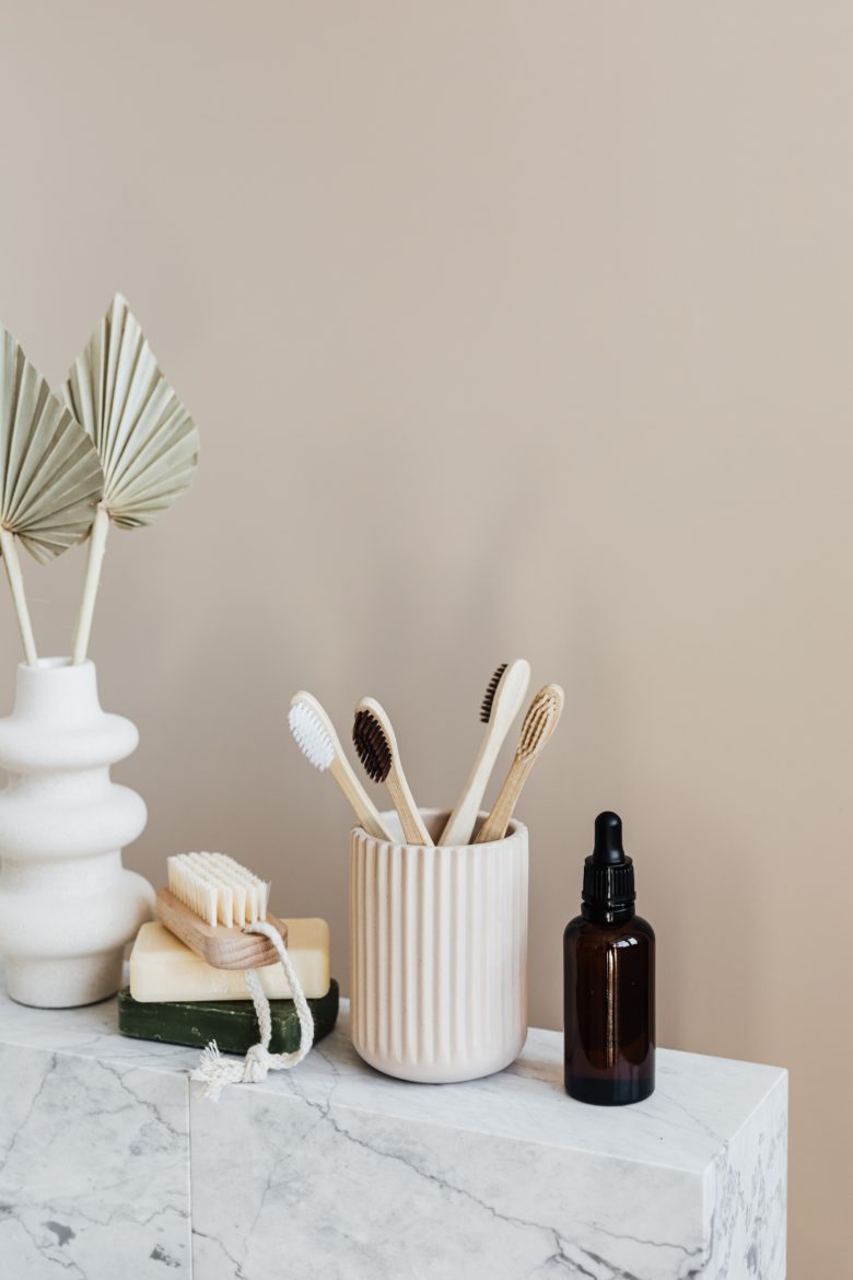 Argan Oil Next to a Tooth Brush Container and Other Things