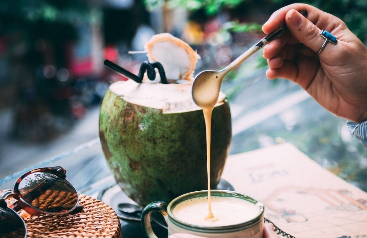 A Coconut Placed Beside a Cup of Coffee